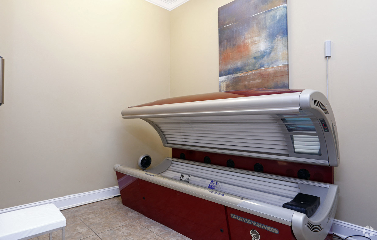 a room with a cooler and a painting on the wall