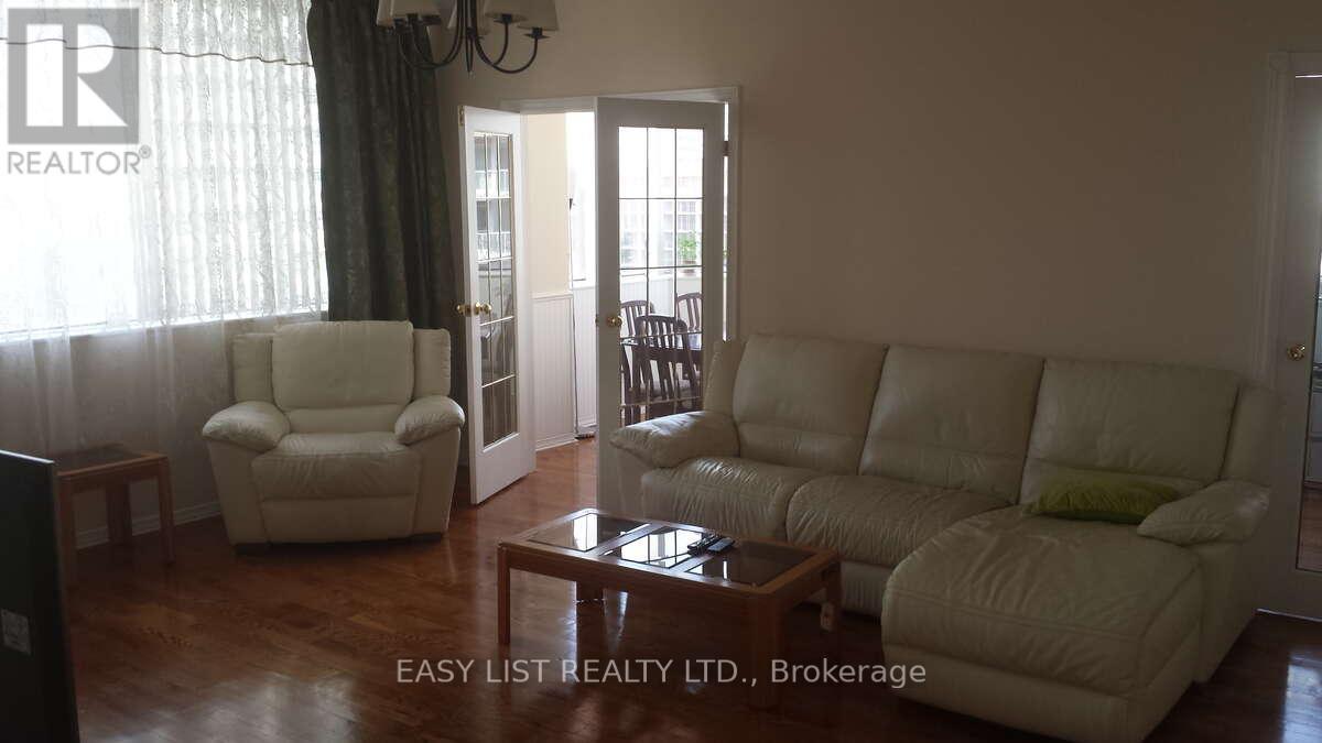 A living room with a couch, chair, and coffee table.