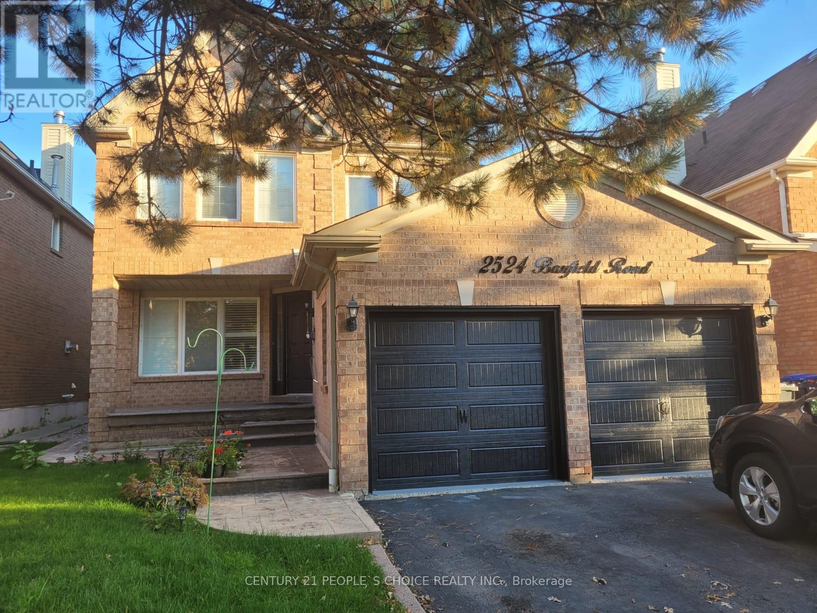 A house with a garage and a car parked in front.