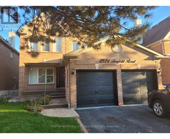 A house with a garage and a car parked in front.