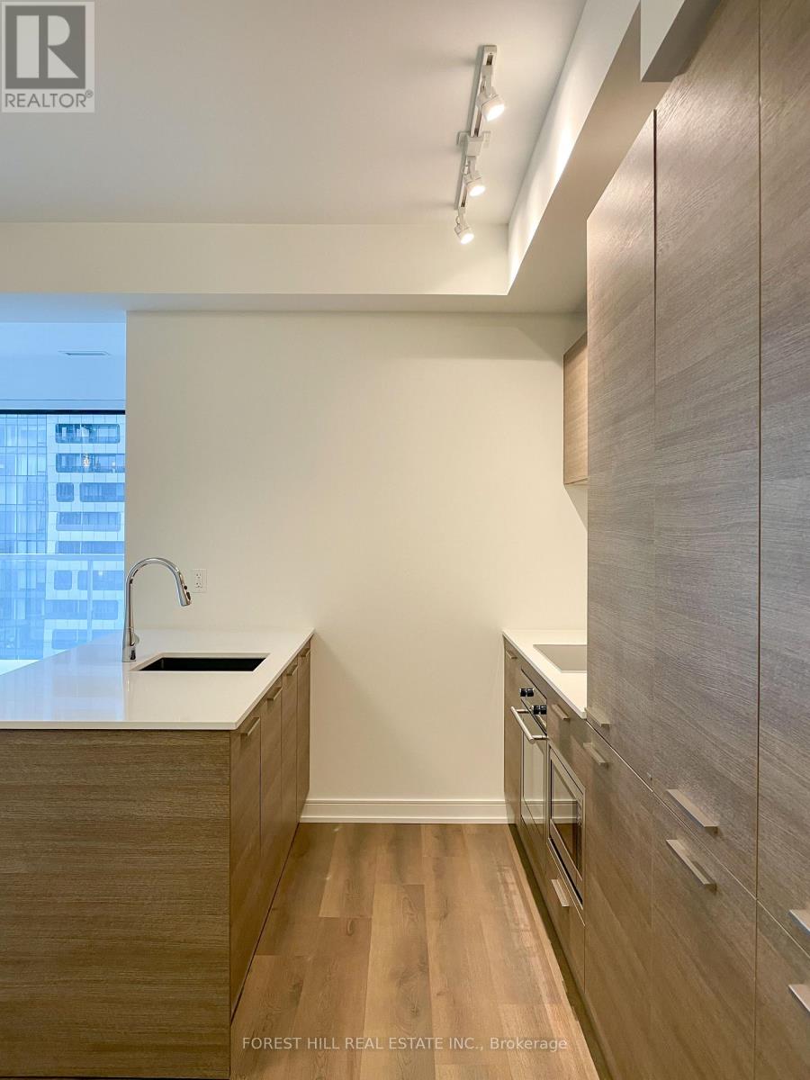 A modern kitchen with wooden cabinets and a white countertop.