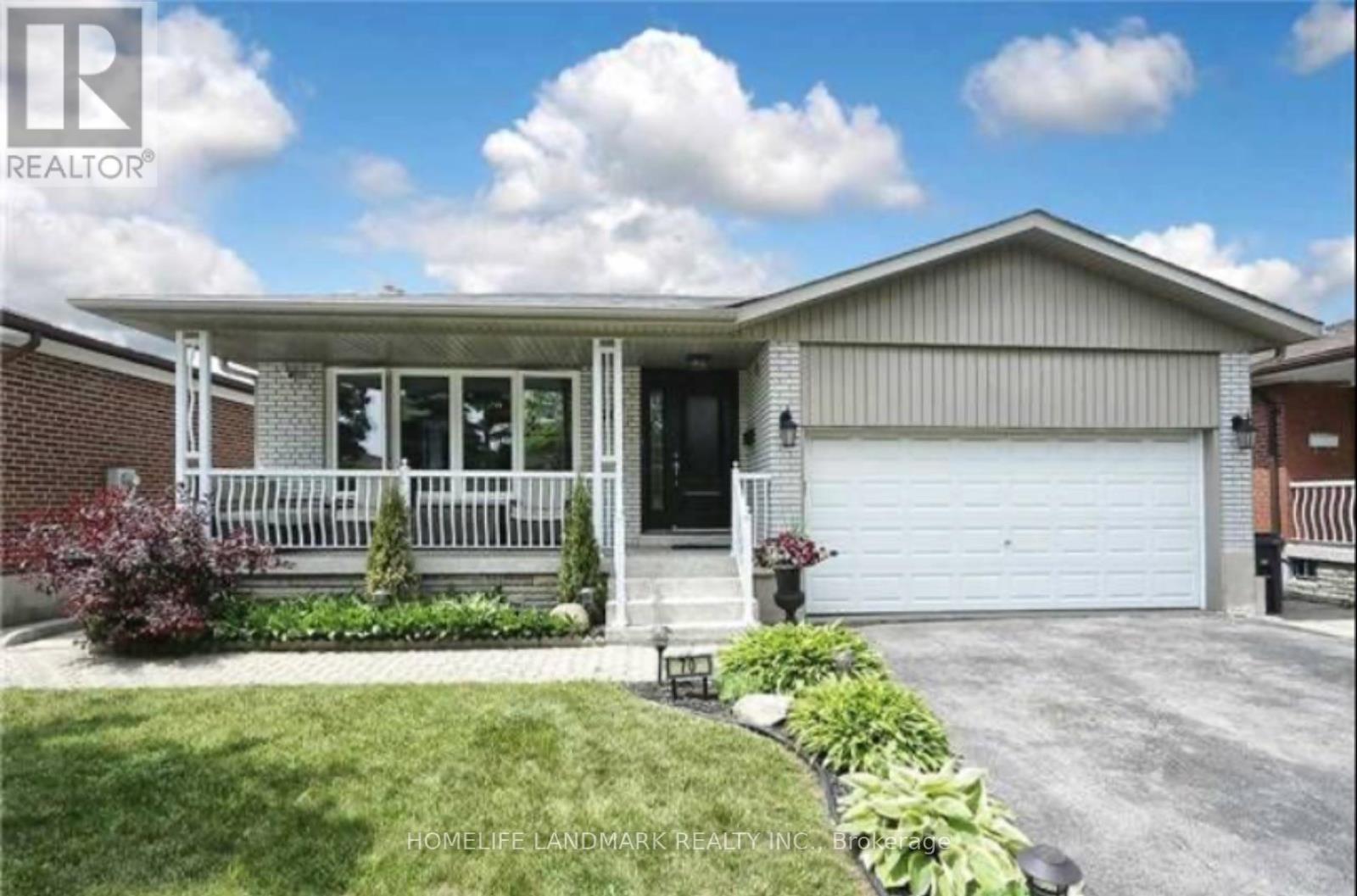 A house with a well-maintained lawn and landscaping in front.