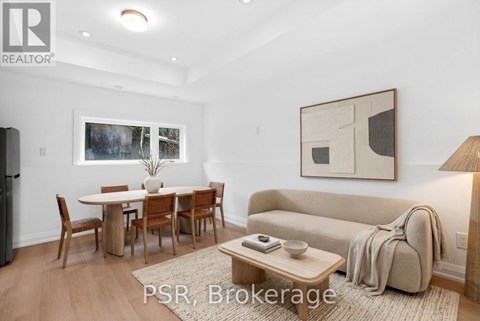 A living room with a dining table and chairs.