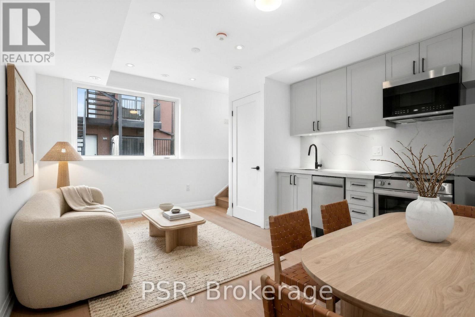 A modern kitchen with a dining table and chairs.