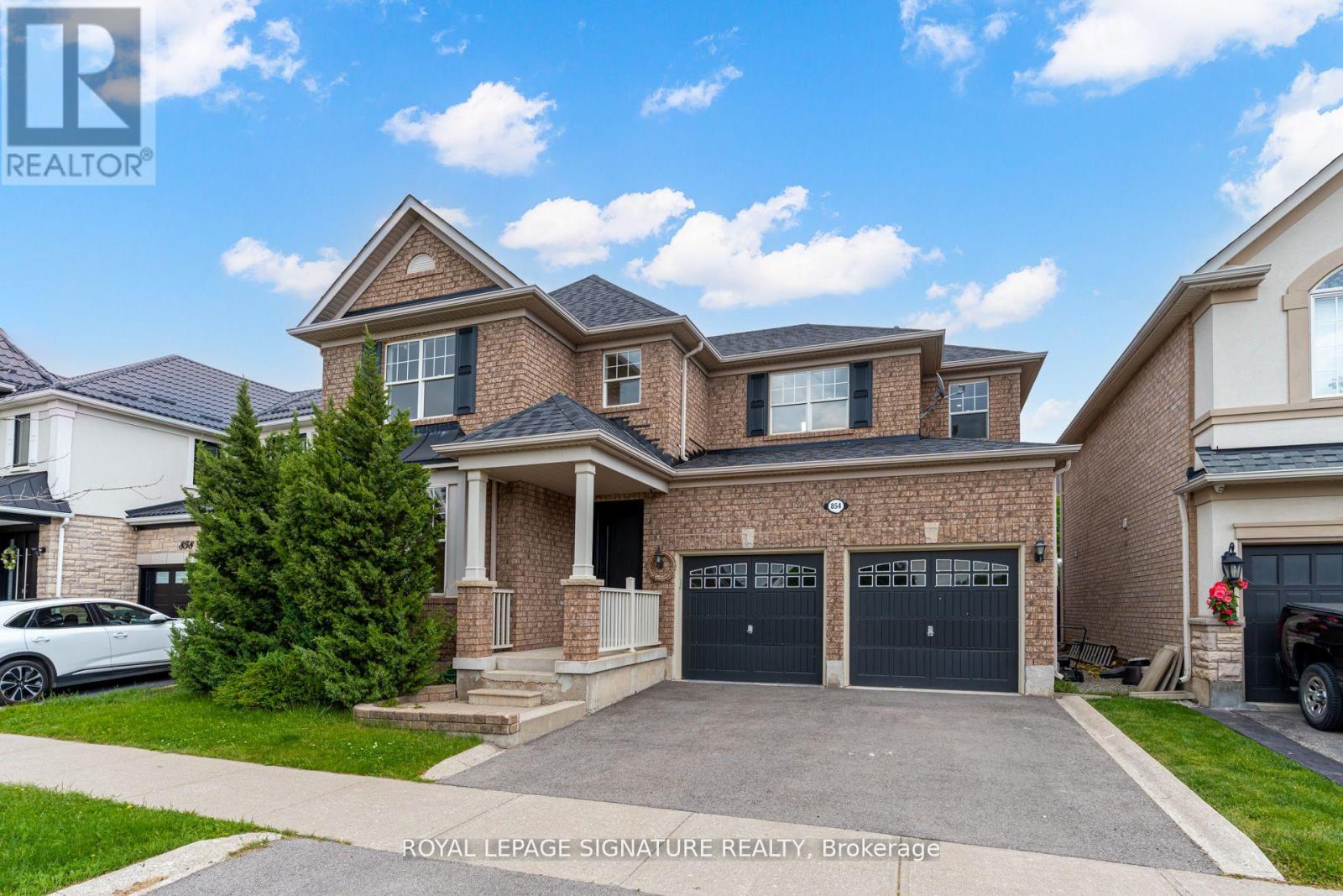 A large, two-story house with a garage is for sale in Brockville.