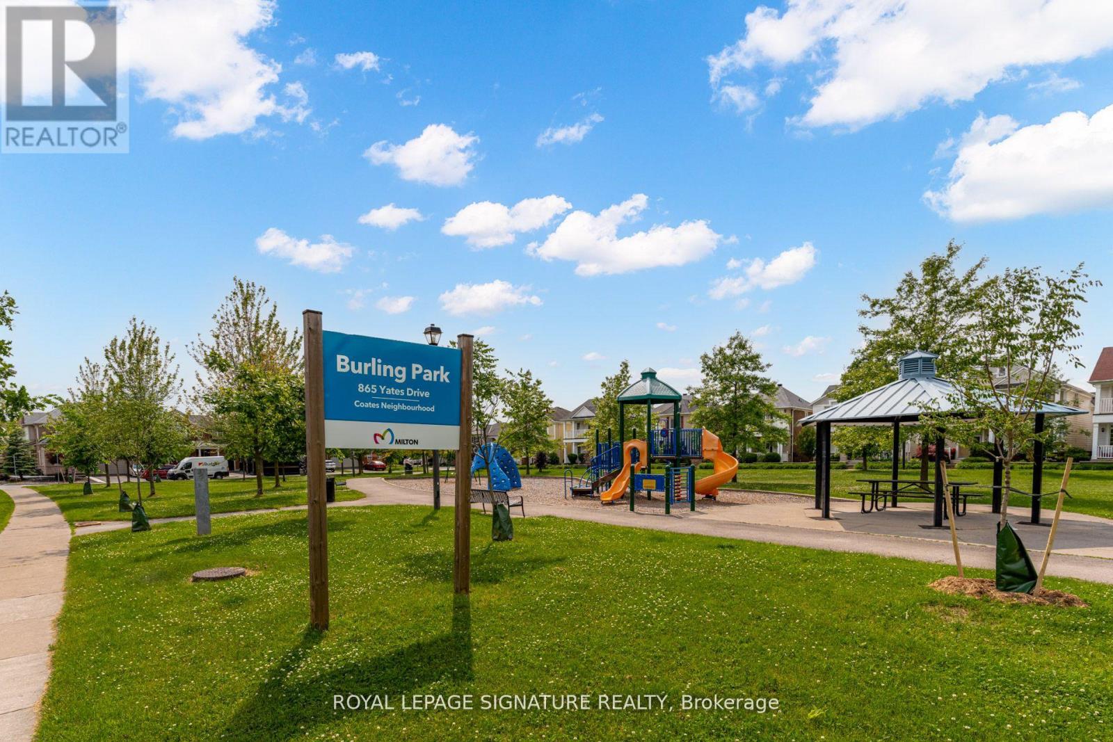 A sign for Burlington Bay Park is in front of a playground.