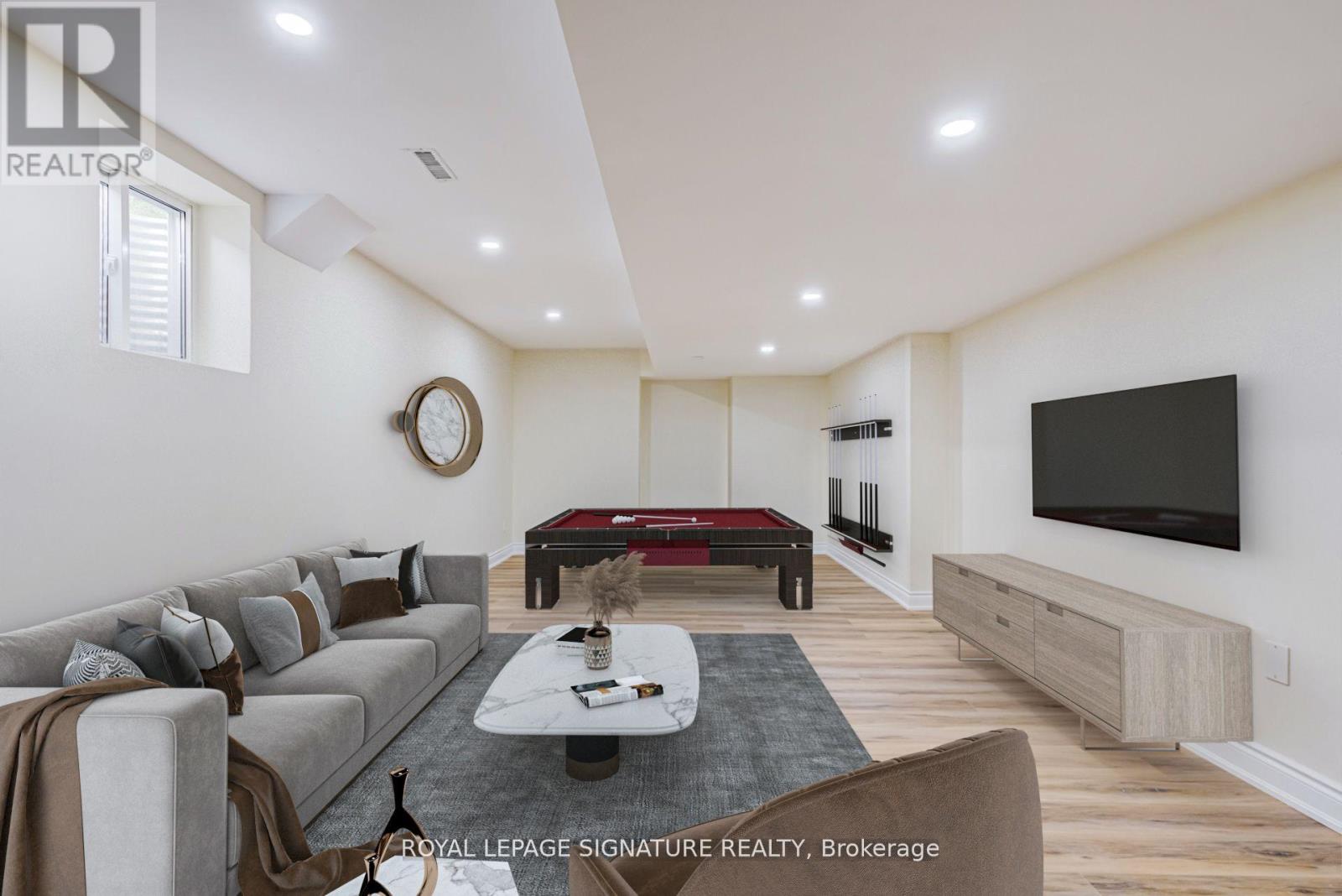A living room with a grey sofa and a black television.
