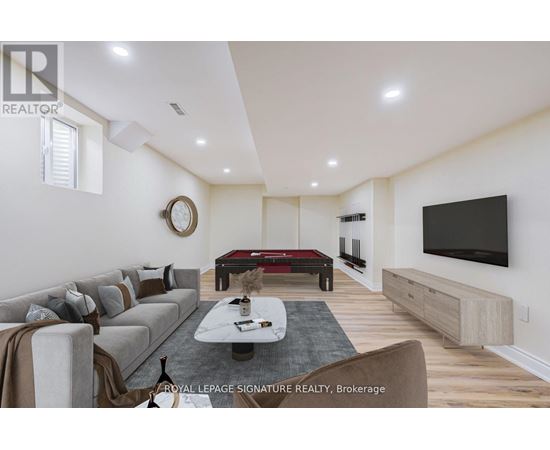 A living room with a grey sofa and a black television.