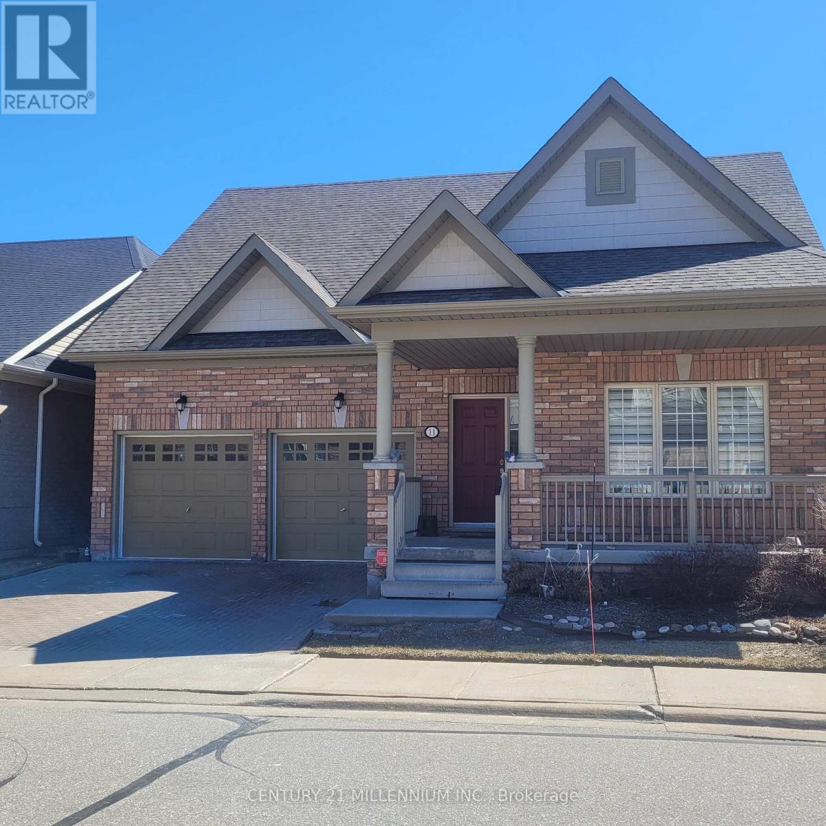 A house with a brick facade and a garage door.
