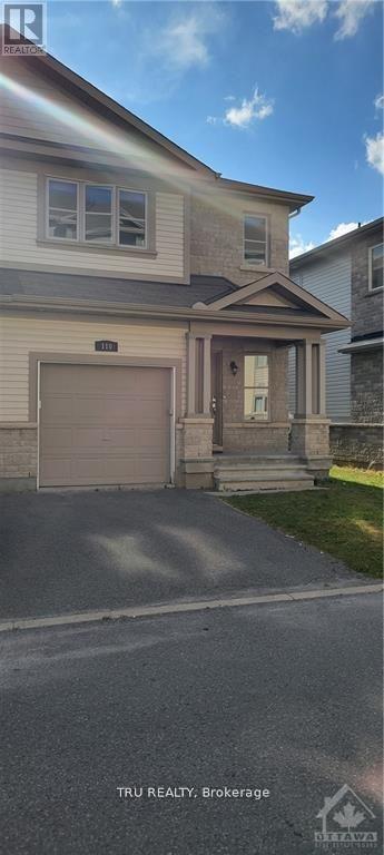 A house with a garage door and a driveway in front.