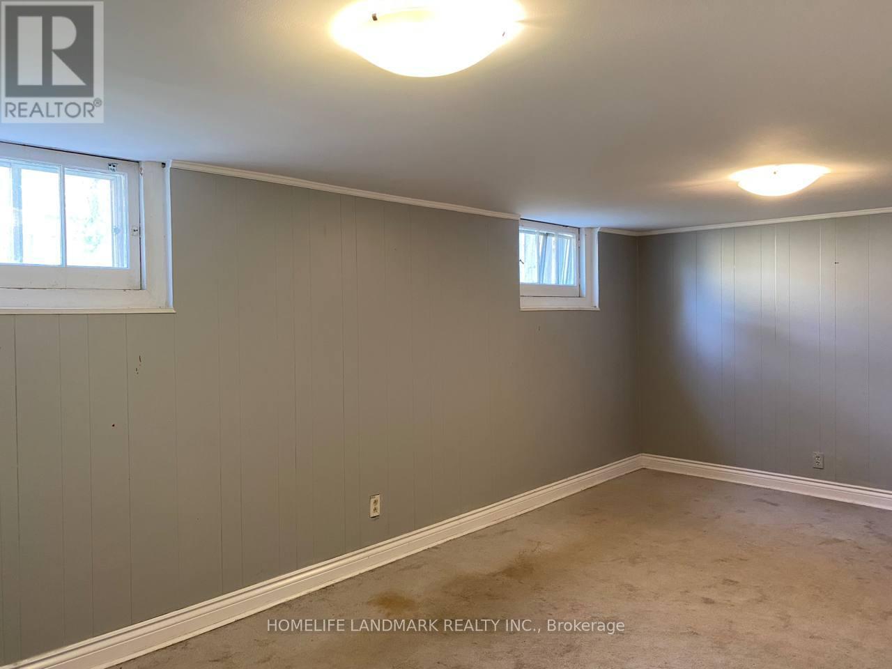 A room with a window and a wall with a logo that says REALTOR.