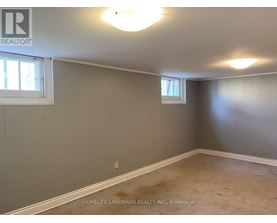 A room with a window and a wall with a logo that says REALTOR.