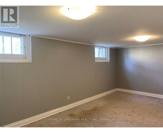 A room with a window and a wall with a logo that says REALTOR.