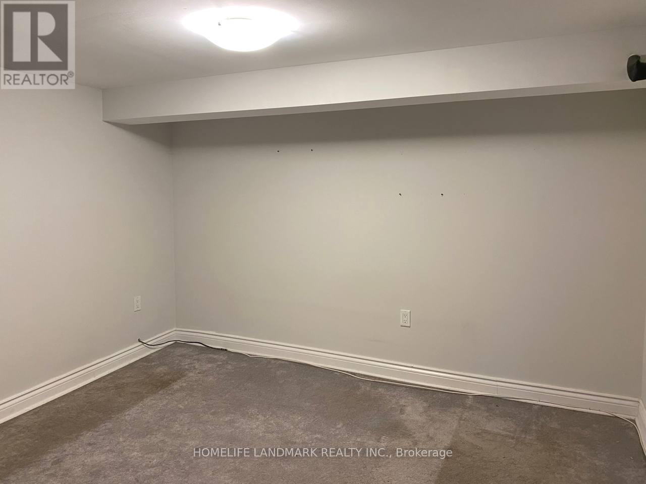 A room with a carpeted floor and white walls.
