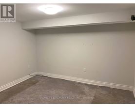 A room with a carpeted floor and white walls.