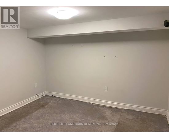 A room with a carpeted floor and white walls.