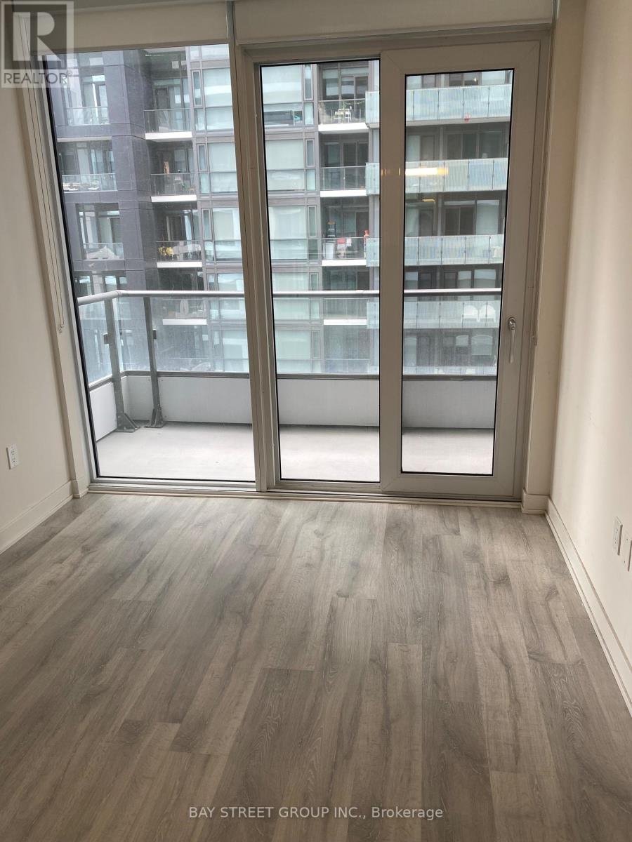 A room with a view of a building across the street.