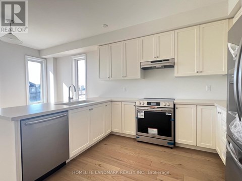 A kitchen with white cabinets and a stainless steel dishwasher.