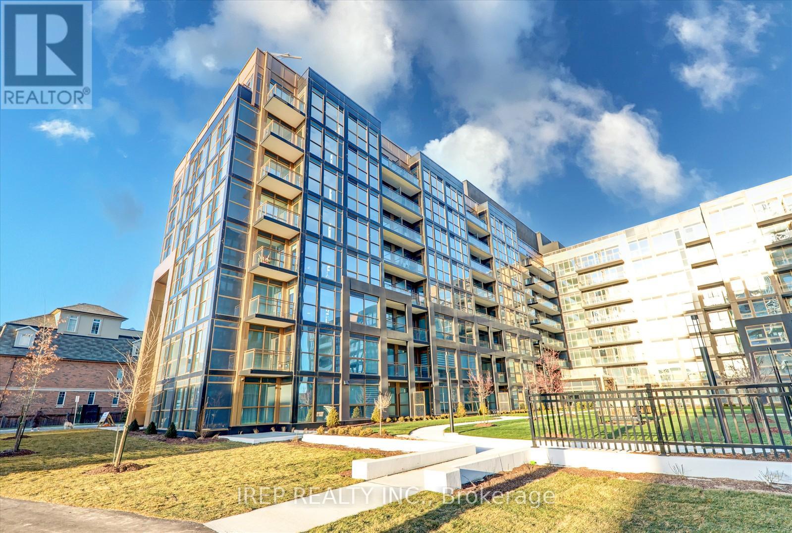 A modern multi-story building with a glass facade is the main focus of the image.