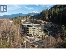 A large building with a mountain in the background.