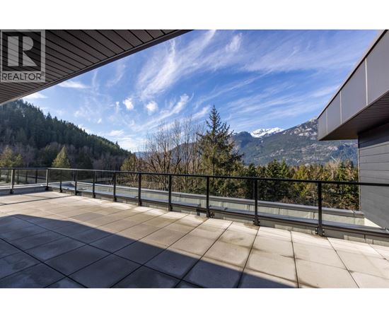 A balcony with a view of a mountain range.