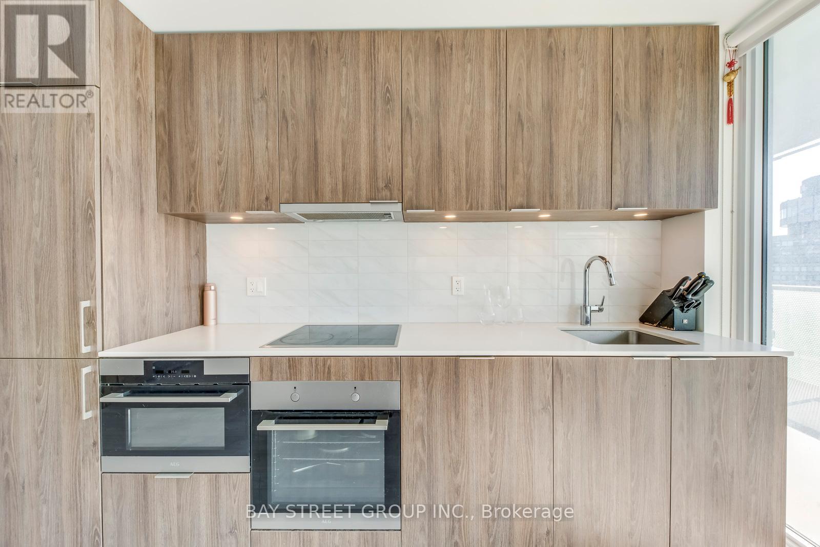 A modern kitchen with wooden cabinets and stainless steel appliances.