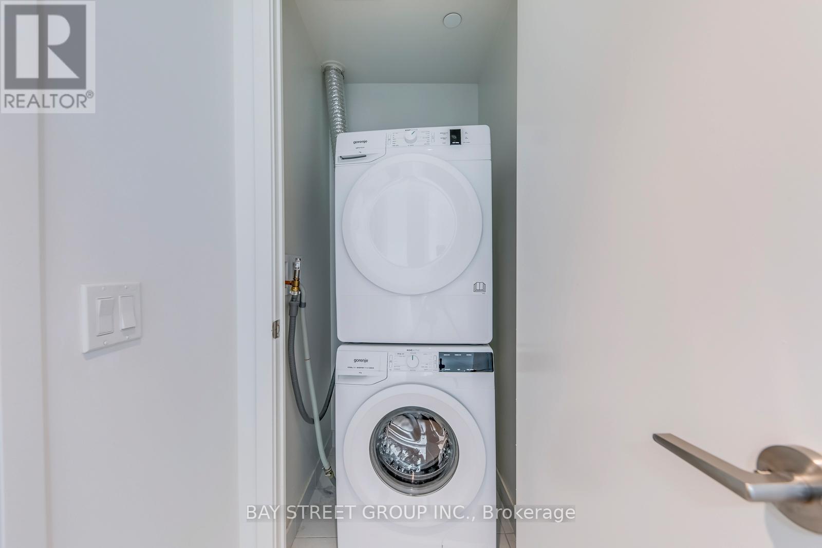 A white washing machine is installed in a small space.