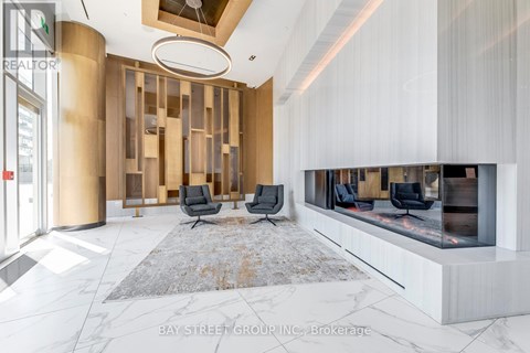 A modern living room with a fireplace and a rug on the floor.