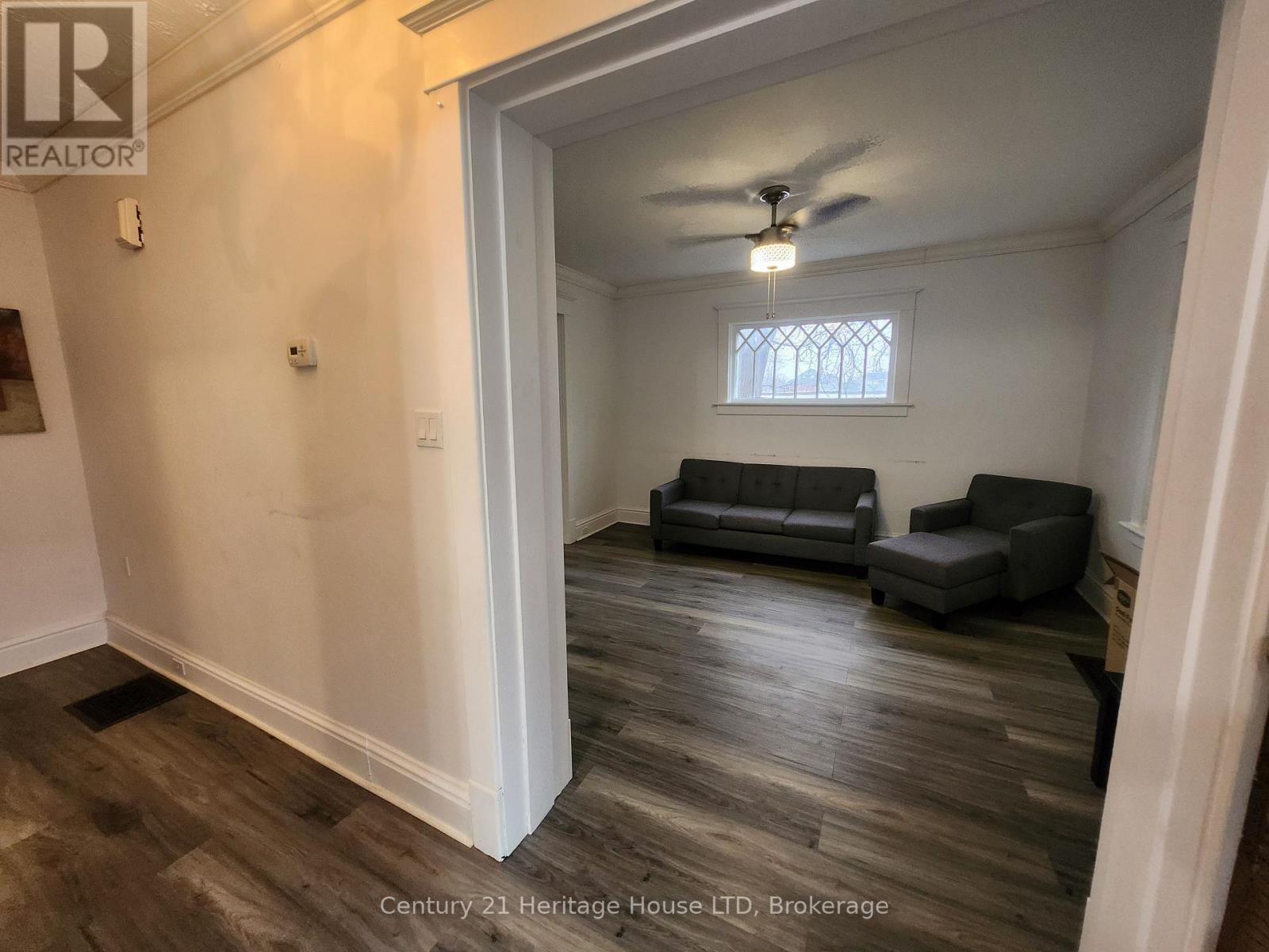 A living room with a couch and a chair.