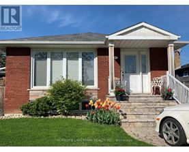 A house with a white porch and a white car parked in front.