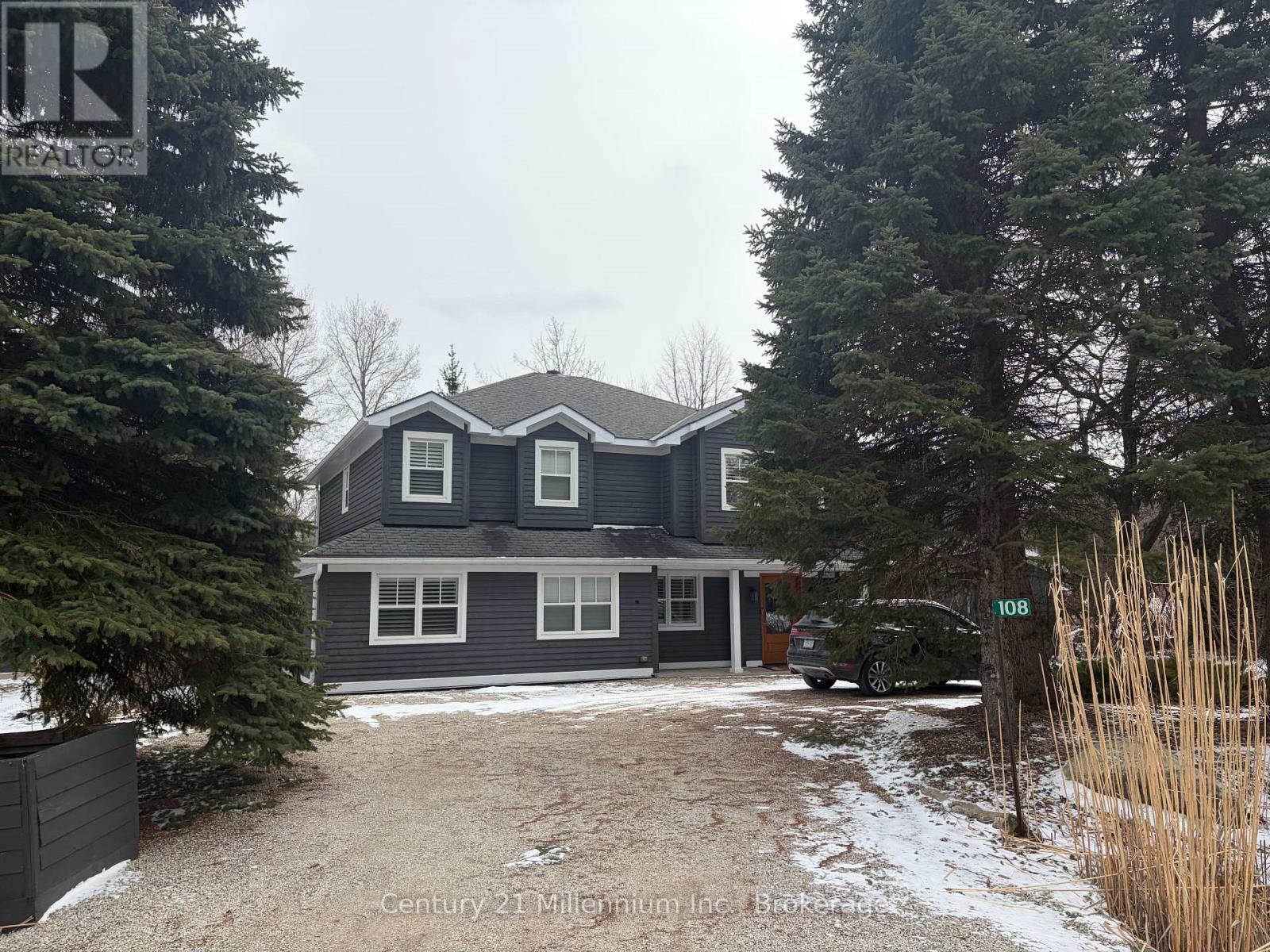 A house with the number 108 on the front yard.