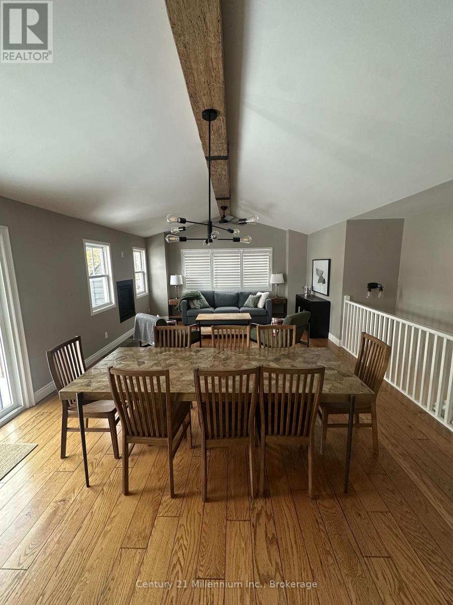 A dining room with a wooden table and chairs.
