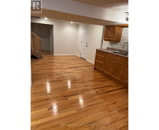 A kitchen with wooden floors and white walls.