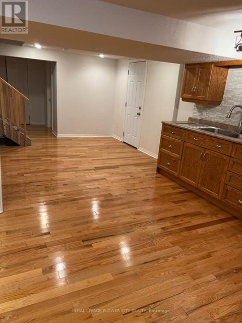 A kitchen with wooden floors and white walls.