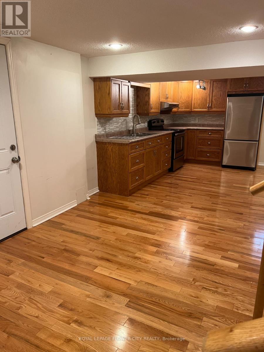 A kitchen with wooden floors and white walls.