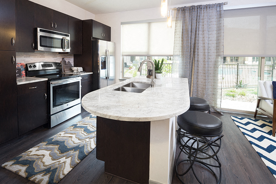 The Addison Apartments in Austin, TX - Granite countertops and espresso cabinets