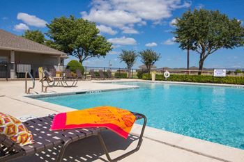 Swimming Pool With Lounge Chairs at Cleburne Terrace Apartments, Cleburne, TX, 76033