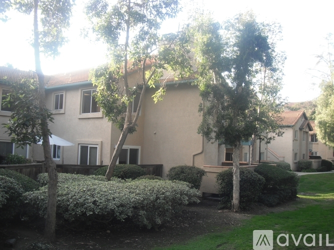 A house with a lawn and trees in front of it.