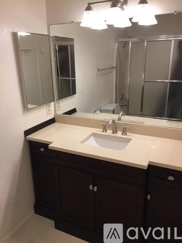 A bathroom with a sink and mirror.