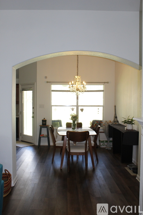 A dining room with a wooden table and chairs.