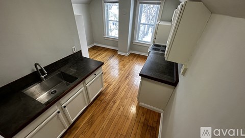 A kitchen with a sink and a window.