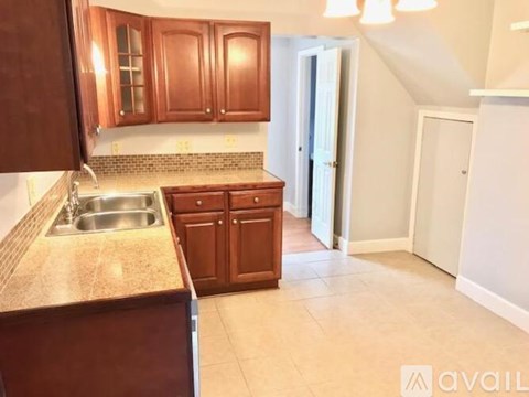 A kitchen with brown cabinets and a sink.