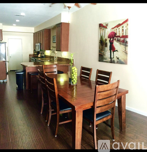A kitchen with a dining table and chairs.