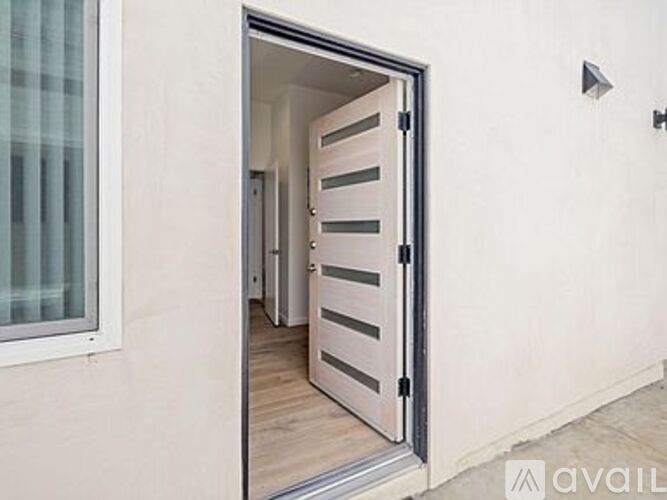 A white door is open to a hallway.