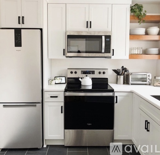 A modern kitchen with a black stove top oven.