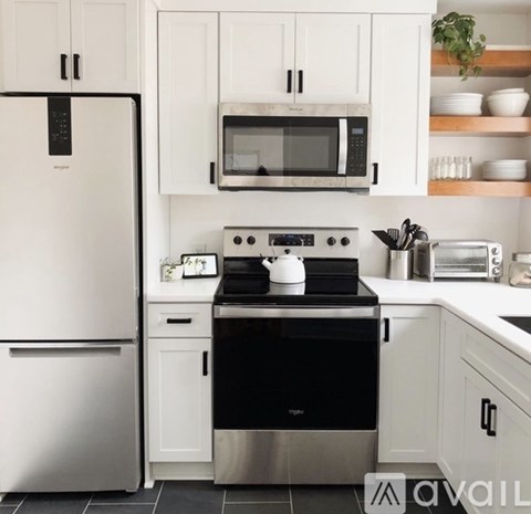 A modern kitchen with a black stove top oven.