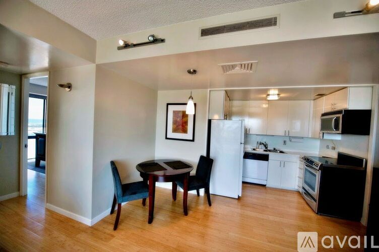 A kitchen with a dining table and chairs.