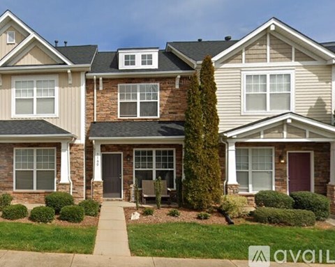 A house with a front yard and a walkway leading to the front door.