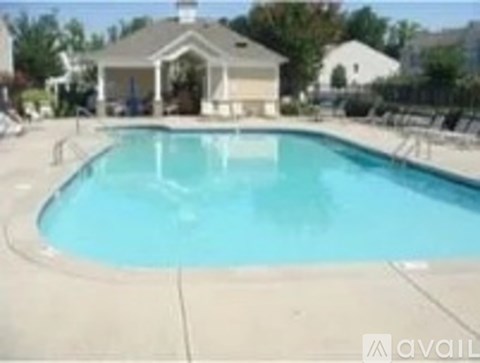 A pool with a small building next to it.