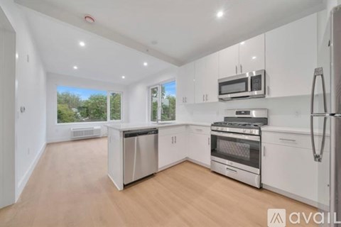 A kitchen with white cabinets and stainless steel appliances.